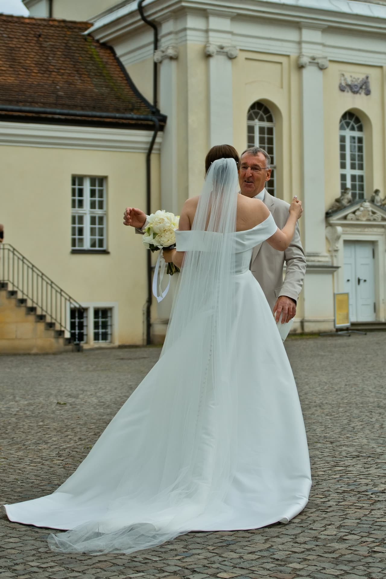 Erster Blick: der Brautvater sieht seine Tochter im Brautkleid vor der Schlosskirche Köpenick