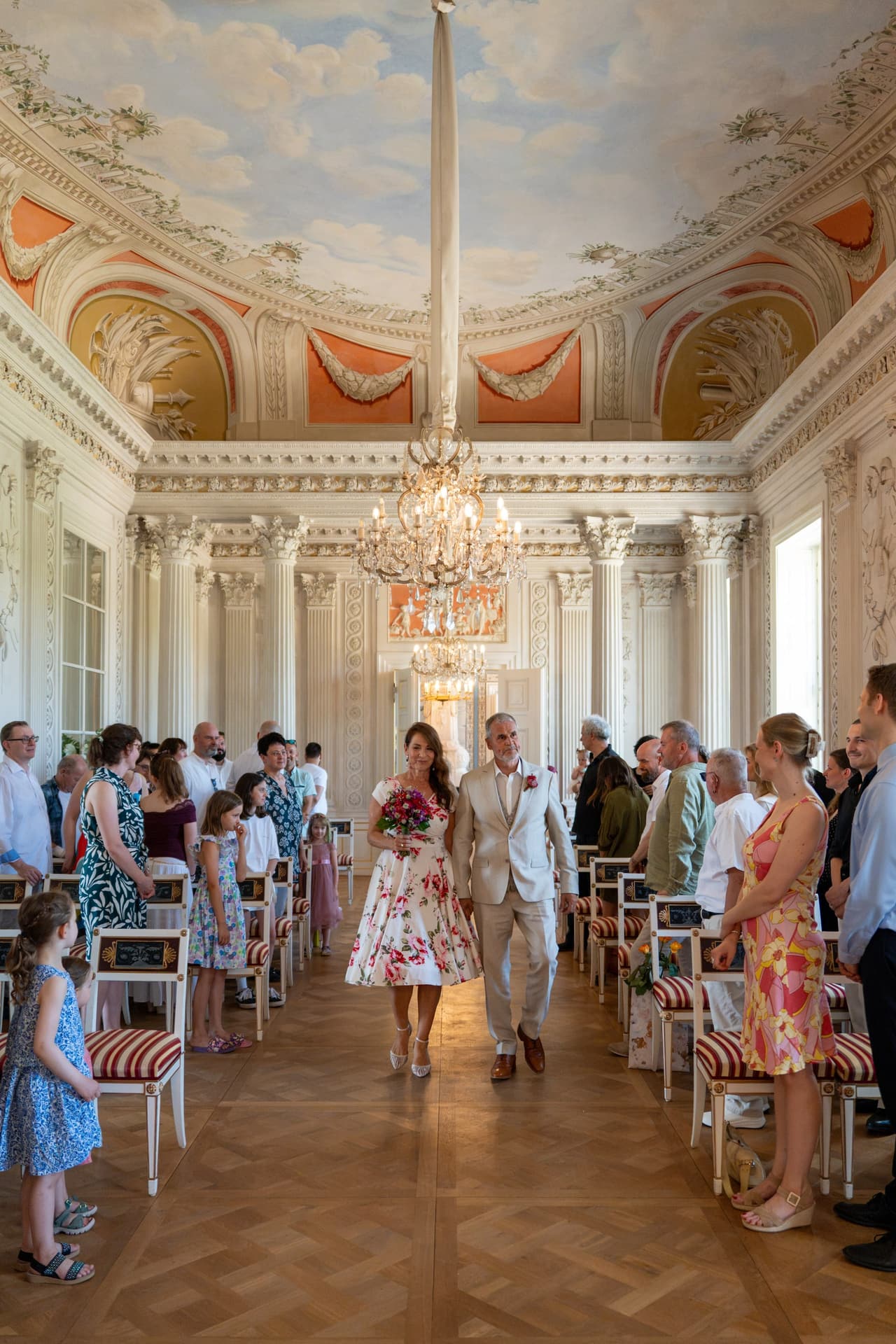 Einzug des Brautpaares zur freien Trauung im Festsaal, die Gäste stehen am Gang